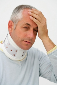 A man holding his head to represent head trauma.
